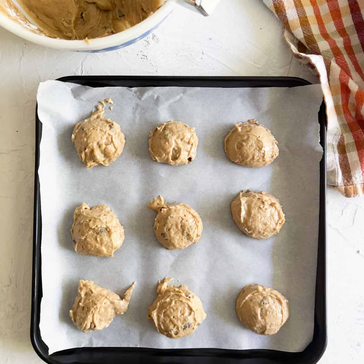 Applesauce cookie dough on square baking sheet.