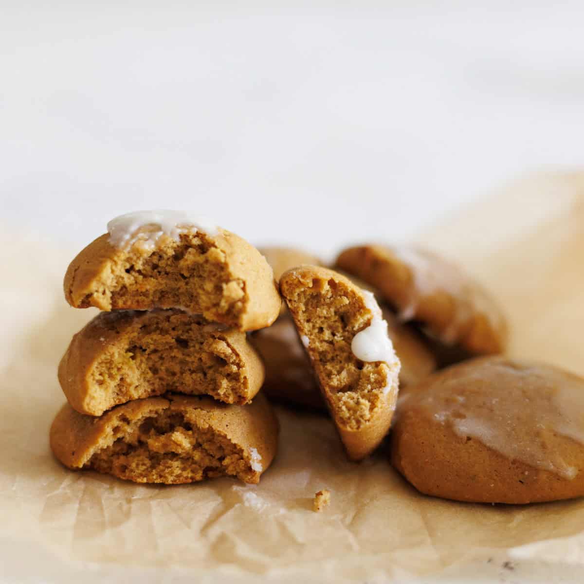 Stacked ginger cream cookies on parchment paper.