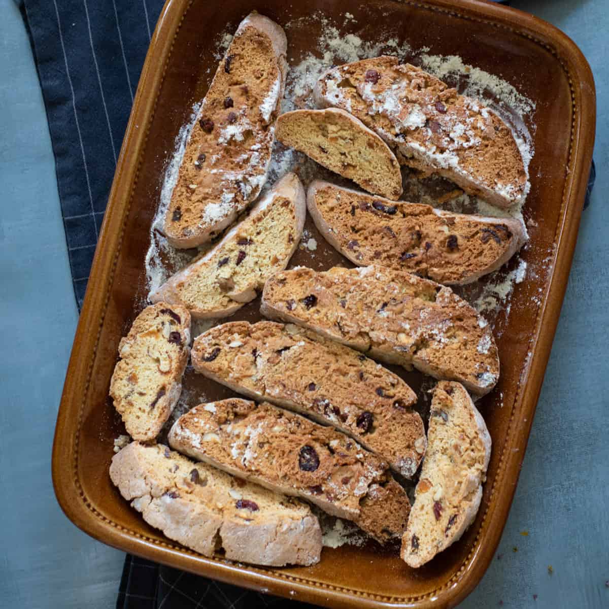 Slices of baked Biscotti in baking dish.