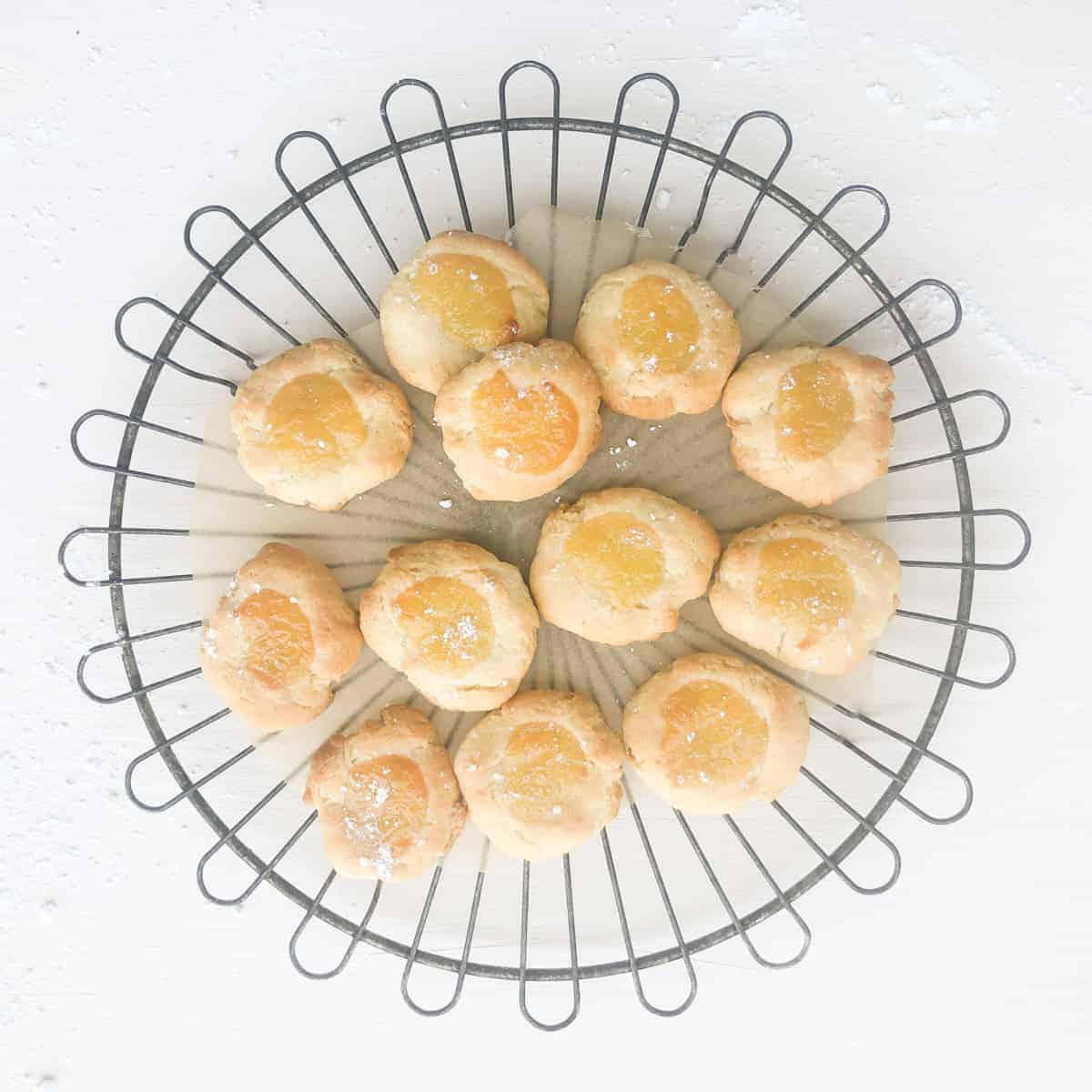 Cream cheese lemon curd cookies on round wire rack.