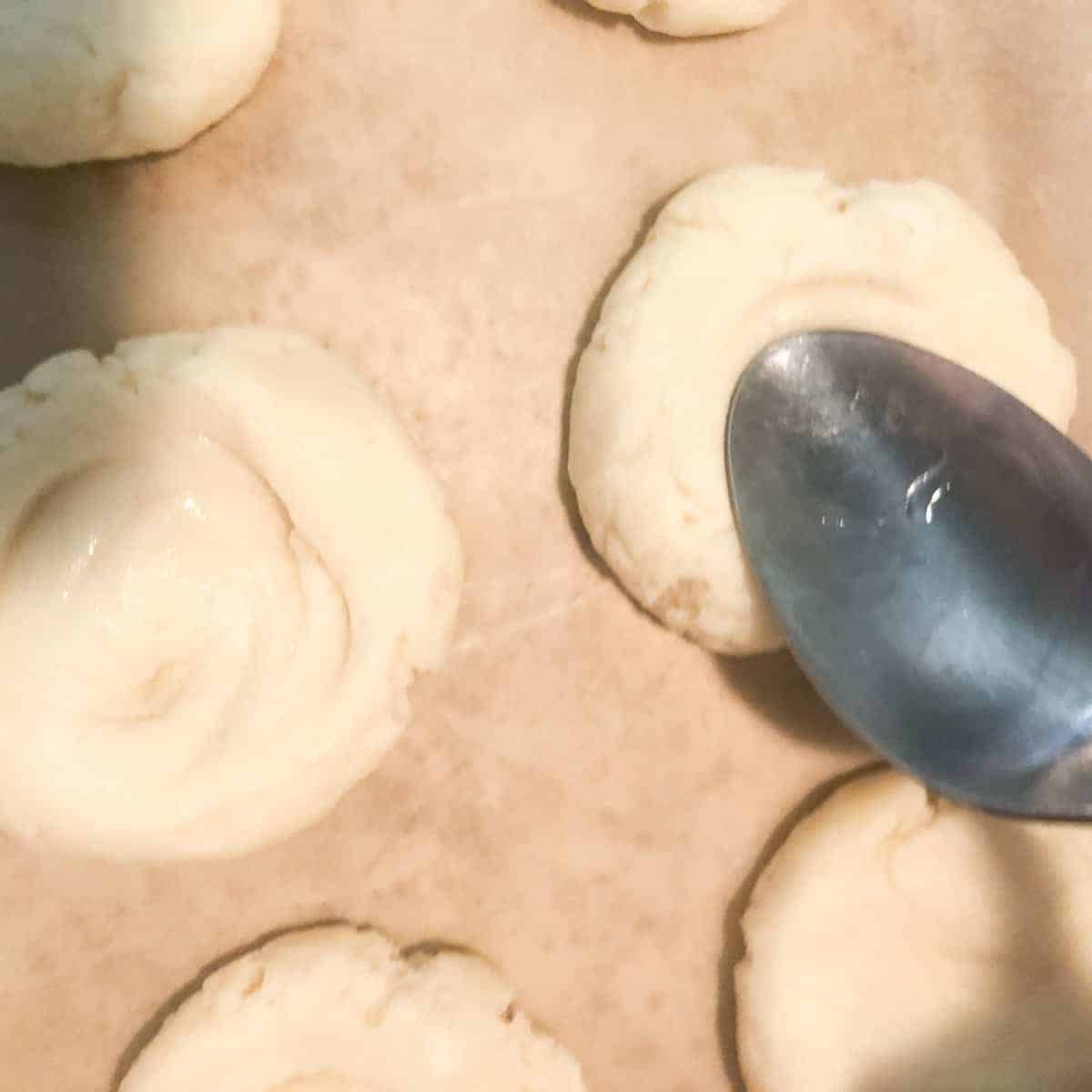 Thumbprint cookies with depression made by spoon.