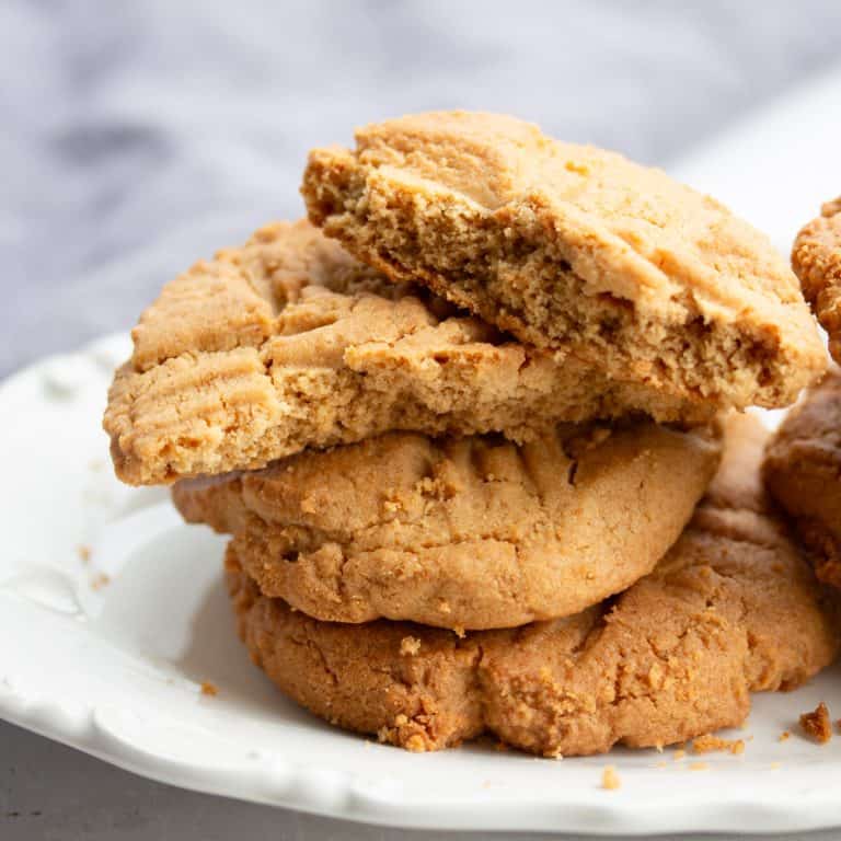 Stack of peanut butter cookies on plate.