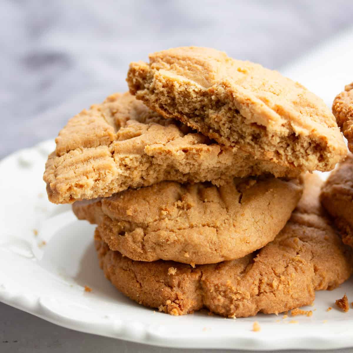 Stack of peanut butter cookies on plate.